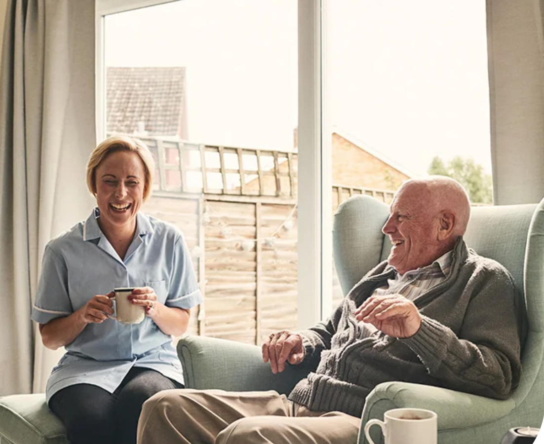 Carer assisting an elderly person at home