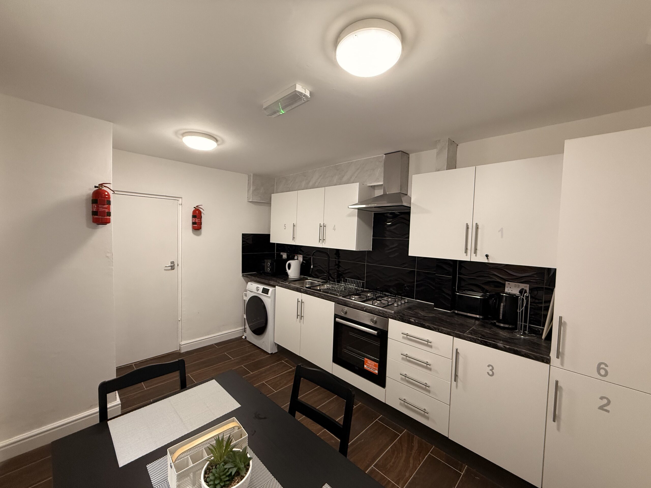 Modern kitchen with white cabinets and dining table
