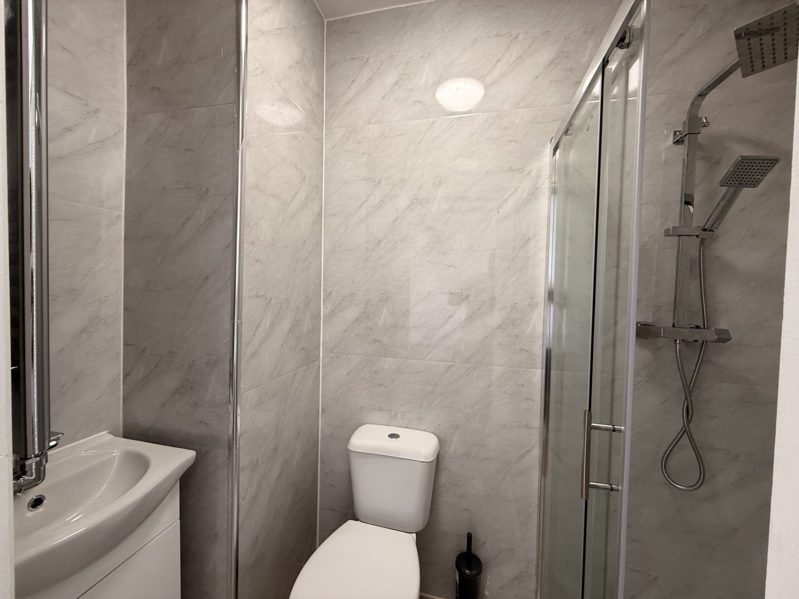 En-suite bathroom with shower, sink and toilet